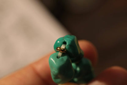 Turquoise bracelet with South Red Agate, showcasing vibrant turquoise stones and a gold accent.